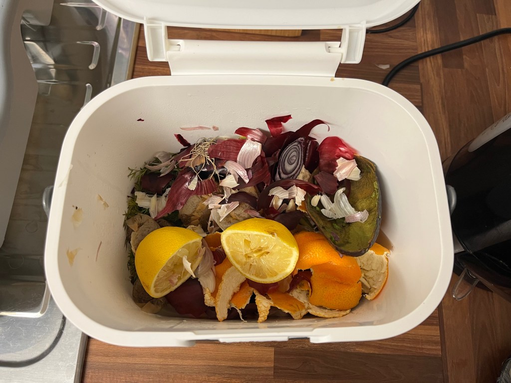 A picture of various kitchen waste greens ready for the compost bin